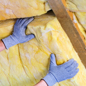 Rockwool insulation getting installed into a wall